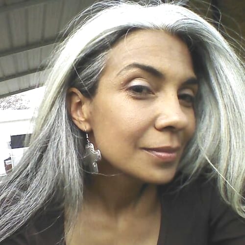 a close up of a person with grey hair.