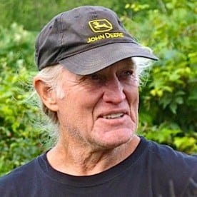 a man wearing a hat and a black shirt.