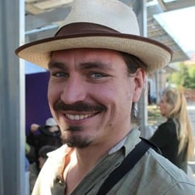 a man with a mustache and a hat.