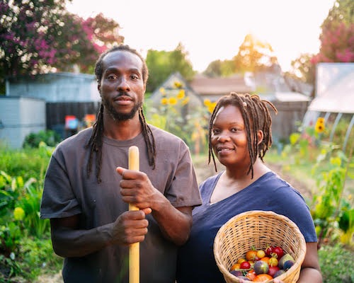 a man and a woman holding a basket of fruit.