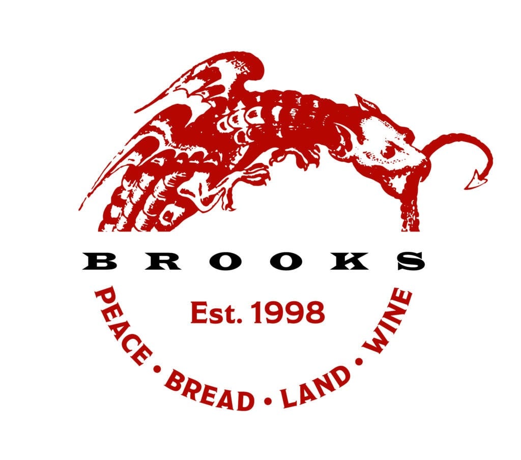 a red and black logo for brooks peace bread land winery.