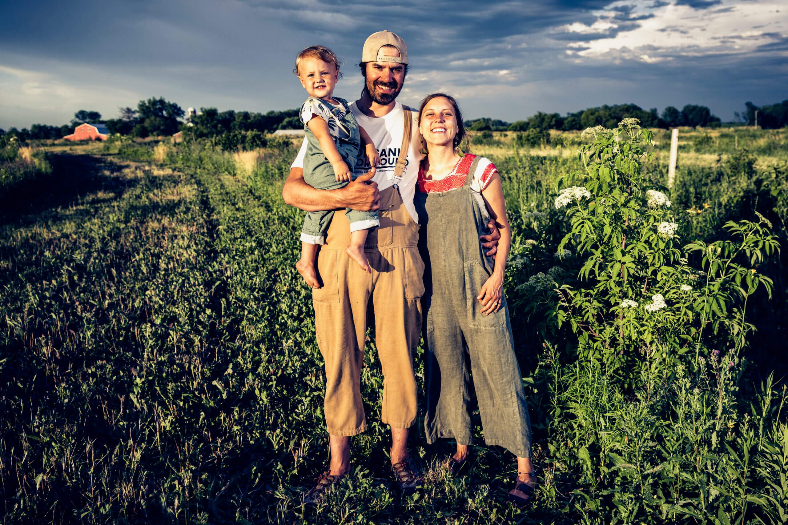 Farmer family standing in a field