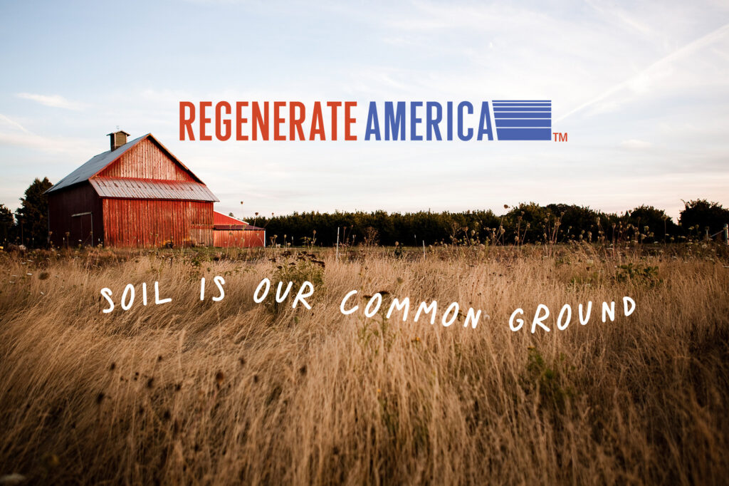 A field with a red barn and the words "regenerate America" on it, inspired by the "kiss the ground" movement.