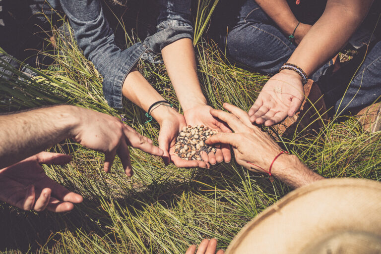 a group of people holding their hands together.