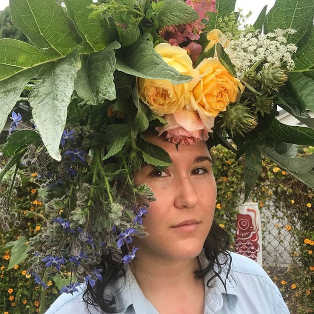 a woman with a flower crown on her head.