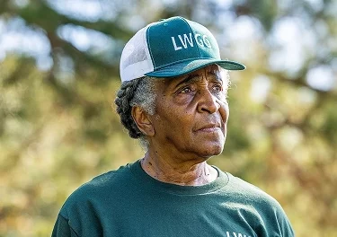 Portrait of a farmer wearing a cap outdoors on a sunny day